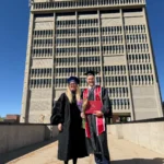 Jake Christensen standing in front of the Social and Behavioral Sciences Tower with the U-CLIMB Lab PI, Jenna.